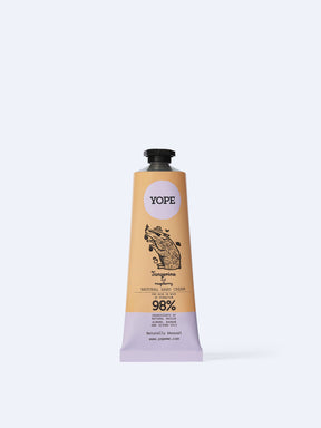 A tan and light purple tube of YOPE Tangerine and Raspberry natural hand cream featuring an illustration of a pig, labelled as 98% ingredients of natural origin.