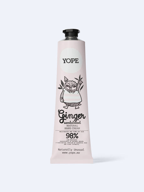 A light pink tube of YOPE Ginger & Sandalwood natural hand cream featuring an illustration of an owl, labelled as 98% low-processed ingredients of natural origin.