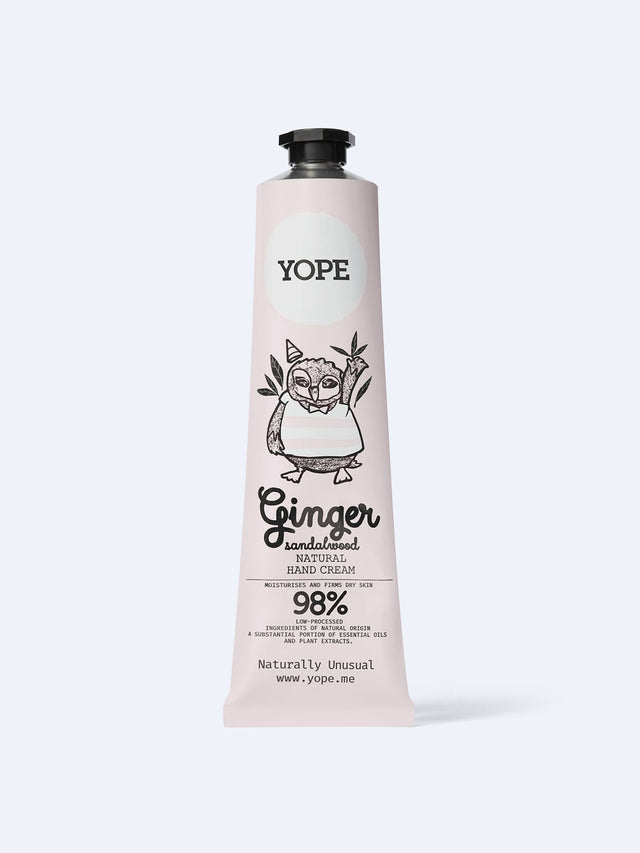 A light pink tube of YOPE Ginger & Sandalwood natural hand cream featuring an illustration of an owl, labelled as 98% low-processed ingredients of natural origin.