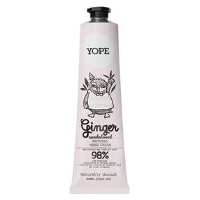 A light pink tube of YOPE Ginger & Sandalwood natural hand cream featuring an illustration of an owl, labelled as 98% low-processed ingredients of natural origin.
