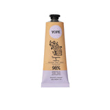 A tan and light purple tube of YOPE Tangerine and Raspberry natural hand cream featuring an illustration of a pig, labelled as 98% ingredients of natural origin.
