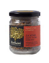 Small glass jar of Zaytoun Za'atar Zesty Thyme Herb Mix from Palestine, featuring a black lid and a red and black label with a gold tree logo.