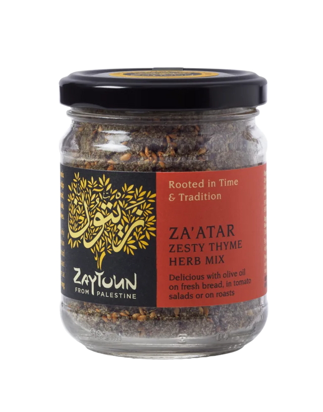 Small glass jar of Zaytoun Za'atar Zesty Thyme Herb Mix from Palestine, featuring a black lid and a red and black label with a gold tree logo.