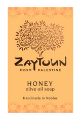 A rectangular soap bar label or packaging card for Zaytoun Honey Olive Oil Soap, featuring a warm orange background with a stylized olive tree logo and text reading 'Zaytoun From Palestine' and 'Honey olive oil soap Handmade in Nablus'.