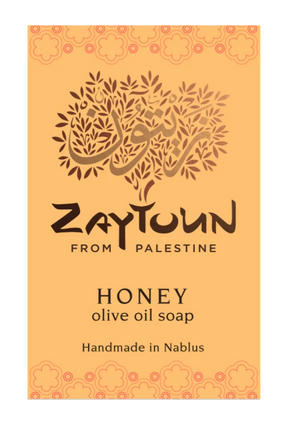 A rectangular soap bar label or packaging card for Zaytoun Honey Olive Oil Soap, featuring a warm orange background with a stylized olive tree logo and text reading 'Zaytoun From Palestine' and 'Honey olive oil soap Handmade in Nablus'.