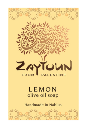 A rectangular soap bar labeled 'Zaytoun From Palestine Lemon olive oil soap' on a pale yellow background with decorative floral borders and a stylized tree logo.