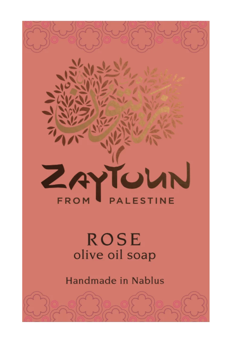 A rectangular soap bar label or package front for Zaytoun From Palestine Rose olive oil soap. The background is a muted dusty rose/coral color with a decorative floral border at the top and bottom, a stylized tree made of leaves and Arabic calligraphy in the center, and black and gold text reading 'ZAYTOUN FROM PALESTINE', 'ROSE', 'olive oil soap', and 'Handmade in Nablus'.