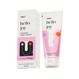 Packaging of "Hello Joy" water-based intimate lubricant is shown. A 100ml pink and white box and tube are displayed against a neutral background.