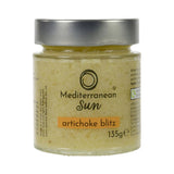 A glass jar with a metal lid labeled "Mediterranean Sun Artichoke Blitz, 135g". The jar contains a yellowish paste, suggesting a creamy artichoke spread.