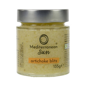 A glass jar with a metal lid labeled "Mediterranean Sun Artichoke Blitz, 135g". The jar contains a yellowish paste, suggesting a creamy artichoke spread.