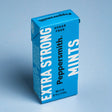 A box of Peppersmith Extra Strong Mints, featuring vibrant blue packaging labeled "Sugar Free" and "With Xylitol