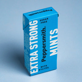A box of Peppersmith Extra Strong Mints, featuring vibrant blue packaging labeled "Sugar Free" and "With Xylitol