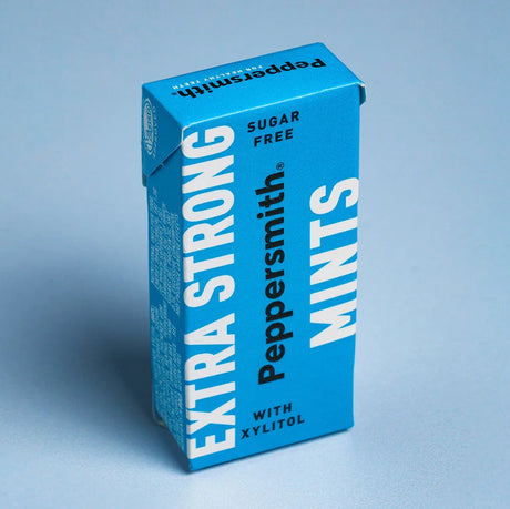 A box of Peppersmith Extra Strong Mints, featuring vibrant blue packaging labeled "Sugar Free" and "With Xylitol