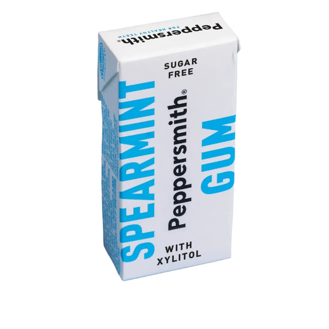A Peppersmith Spearmint Gum carton, white with blue and black text, standing on a light blue background.