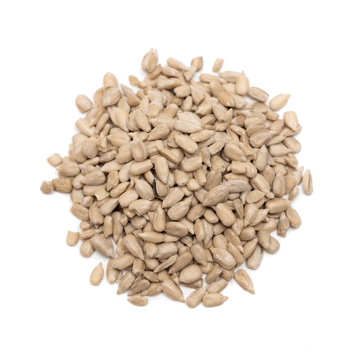 A pile of raw, shelled sunflower seeds isolated on a white background.