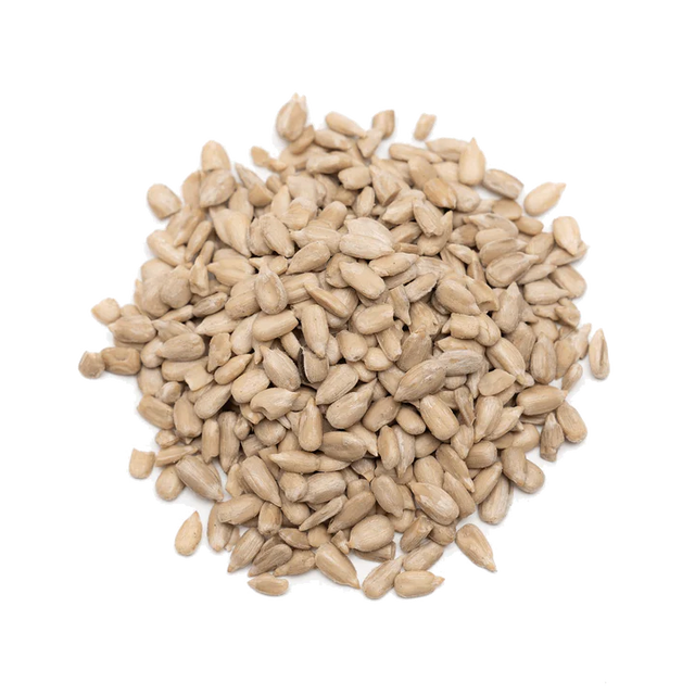 A pile of raw, shelled sunflower seeds isolated on a white background.