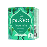 Green box of Pukka Three Mint organic tea, featuring leaf illustrations. Text highlights spearmint, peppermint, and field mint. Contains 8 sachets.