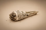 "Small artisan white sage smudge torch, hand-tied with natural twine for cleansing rituals."