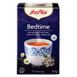 Yogi Tea Bedtime tea box with a cup of tea and tea leaves on a white background