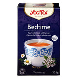 Yogi Tea Bedtime tea box with a cup of tea and tea leaves on a white background