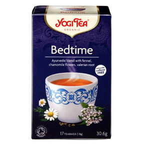 Yogi Tea Bedtime tea box with a cup of tea and tea leaves on a white background